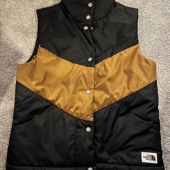 black and gold north face vest